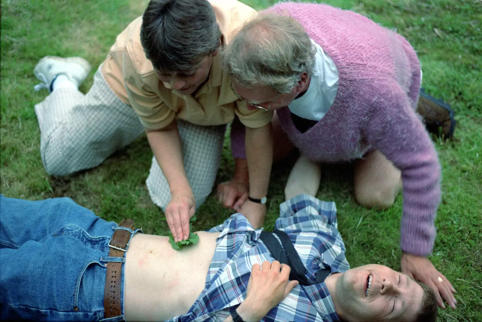 Pippa applies dock leaf to a nettle sting, from DH's Barbeque at The Swan Inn, Brome, Suffolk - July 14th 1996