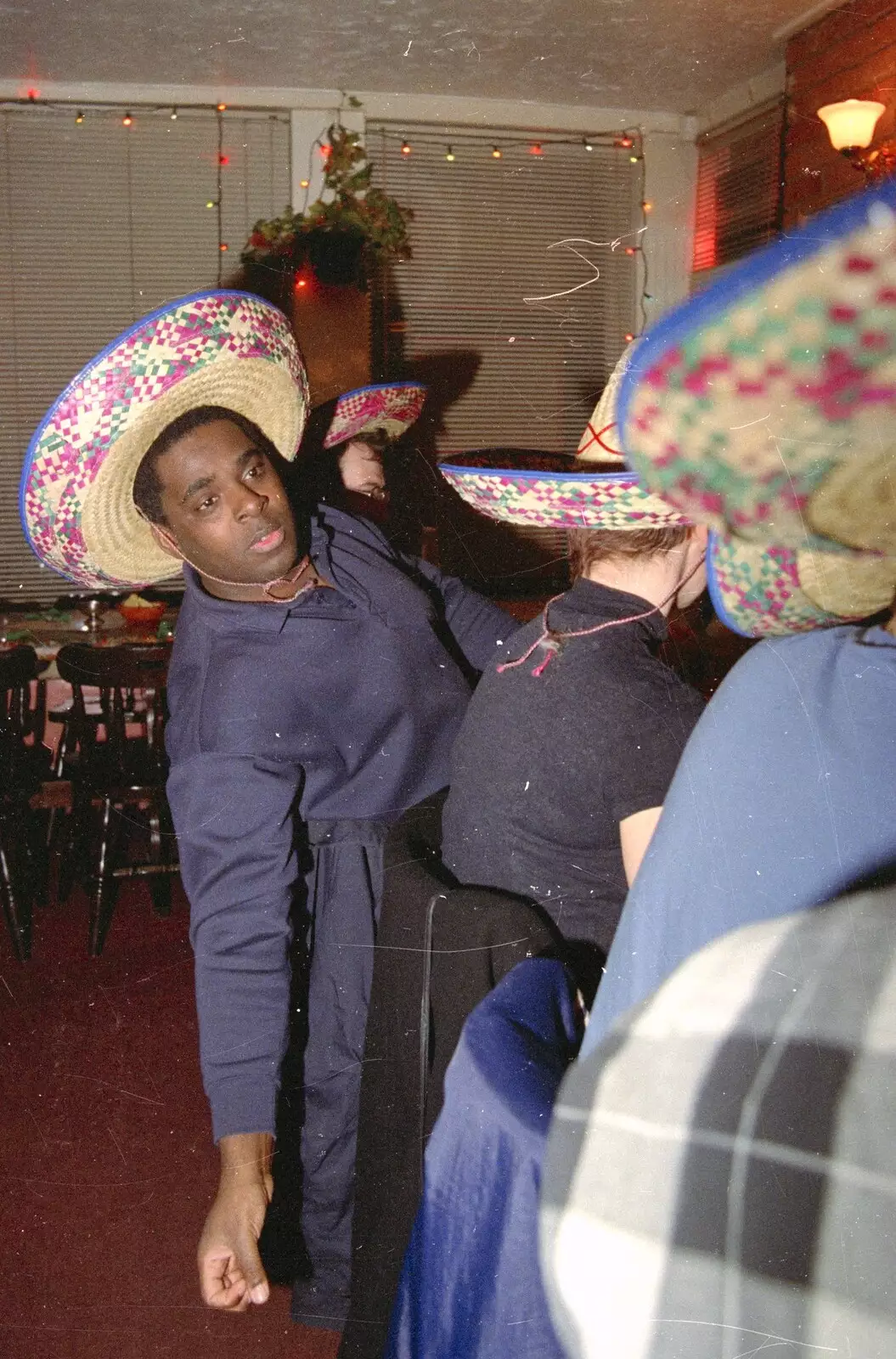 Carl leans over for something, from A CISU Night at Los Mexicanos Restaurant, Ipswich - 15th December 1996