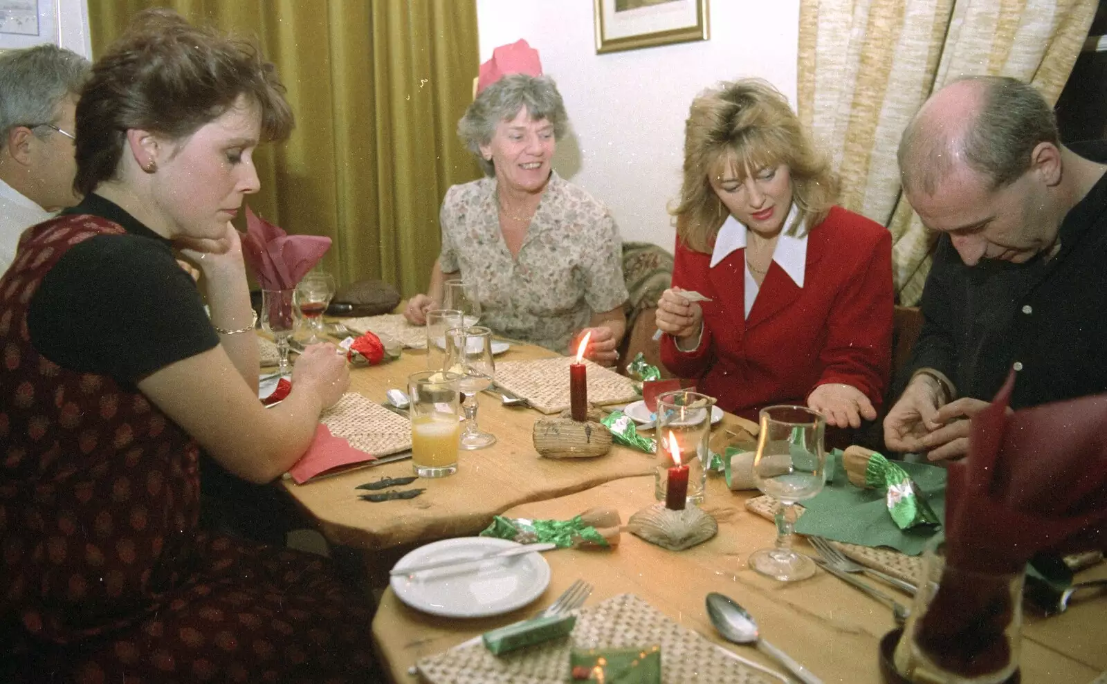 Laura's geezer inspects his cracker, from Hamish's Thirtieth Birthday, Hare and Hounds, Sway, Hampshire - 19th December 1996