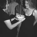 Katherine hands Rainey her birthday cake