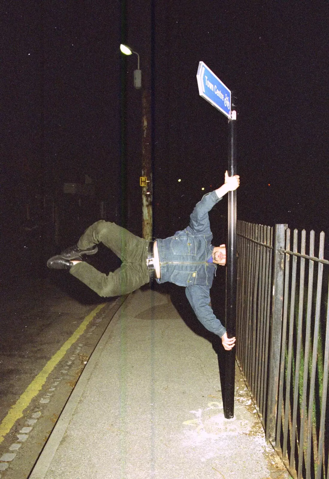 Orhan spins horizontally around a street sign, from CISU: A Chinese Restaurant and SCC Sports Day, Ipswich and Norwich - 1st May 1997