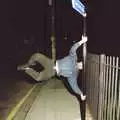 Orhan spins horizontally around a street sign, CISU: A Chinese Restaurant and SCC Sports Day, Ipswich and Norwich - 1st May 1997