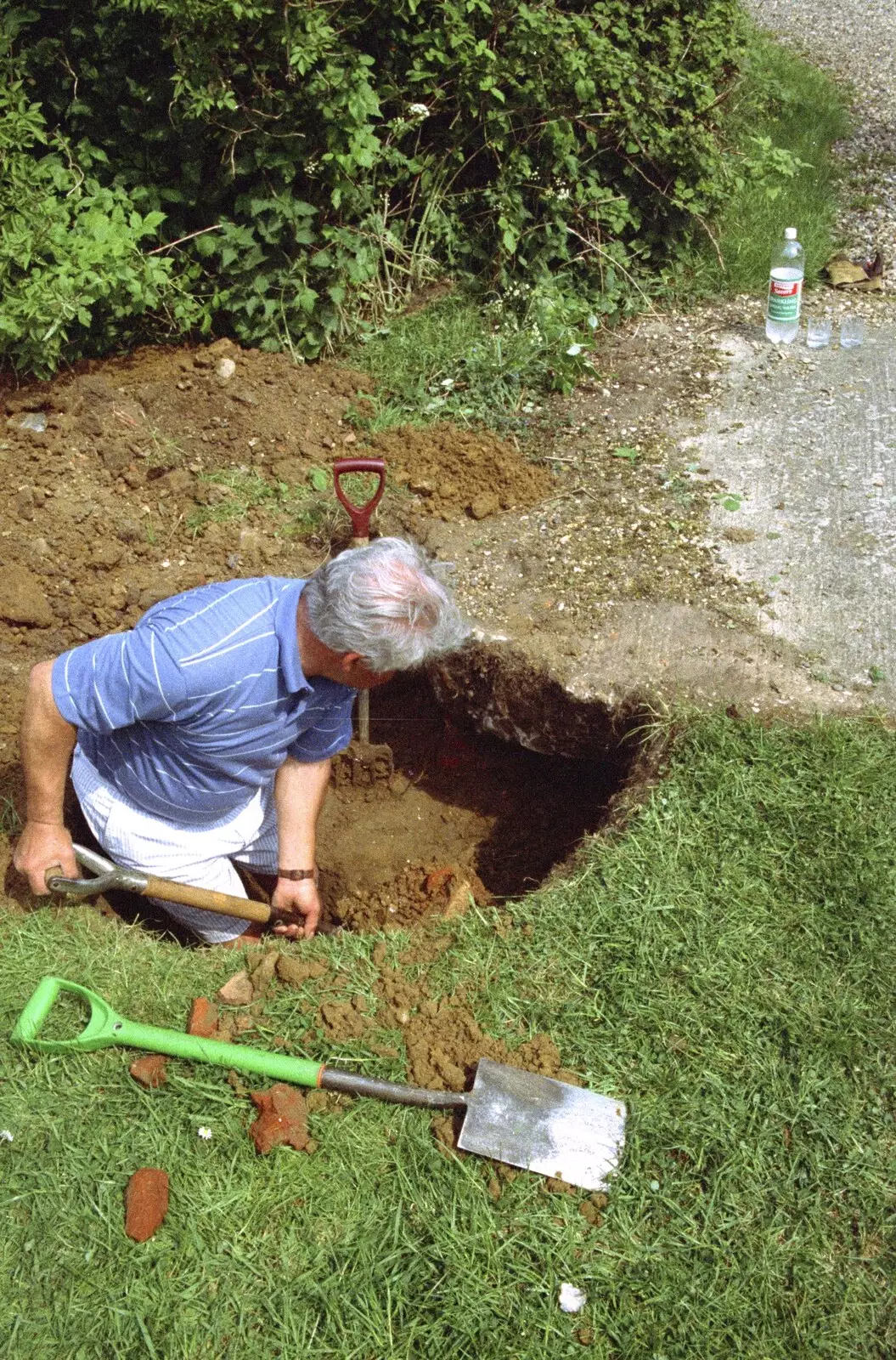 Lou digs an exploratory hole by the side of the well, from Hale-Bopp and Bedroom Demolition, Brome, Suffolk - 10th May 1997