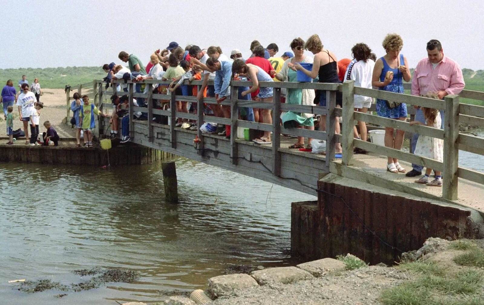 A throng of people go crabbing off the bridge, from BSCC at the Beach, Walberswick, Suffolk - 15th July 1997