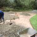Danny rakes out gravel, Garden Rotovator Action, Brome, Suffolk - 28th March 1998