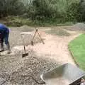 Danny rakes out gravel, Garden Rotovator Action, Brome, Suffolk - 28th March 1998