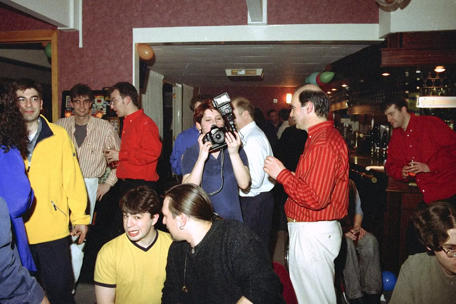 Lisa roams around with a camera, from A CISU Thrash in the SCC Social Club, Rope Walk, Ipswich - 4th April 1998