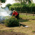 Tony hurls a bush onto the bonfire, Tony and Janet's Building Plot, and the Red Arrows, Eye, Suffolk - 22nd July 1998
