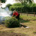 Tony hurls a bush onto the bonfire, Tony and Janet's Building Plot, and the Red Arrows, Eye, Suffolk - 22nd July 1998