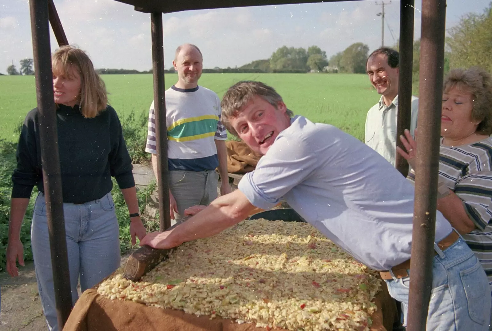 Geoff tamps down chopped apples, from Cider Making With Geoff and Brenda, Stuston, Suffolk - 10th September 1998