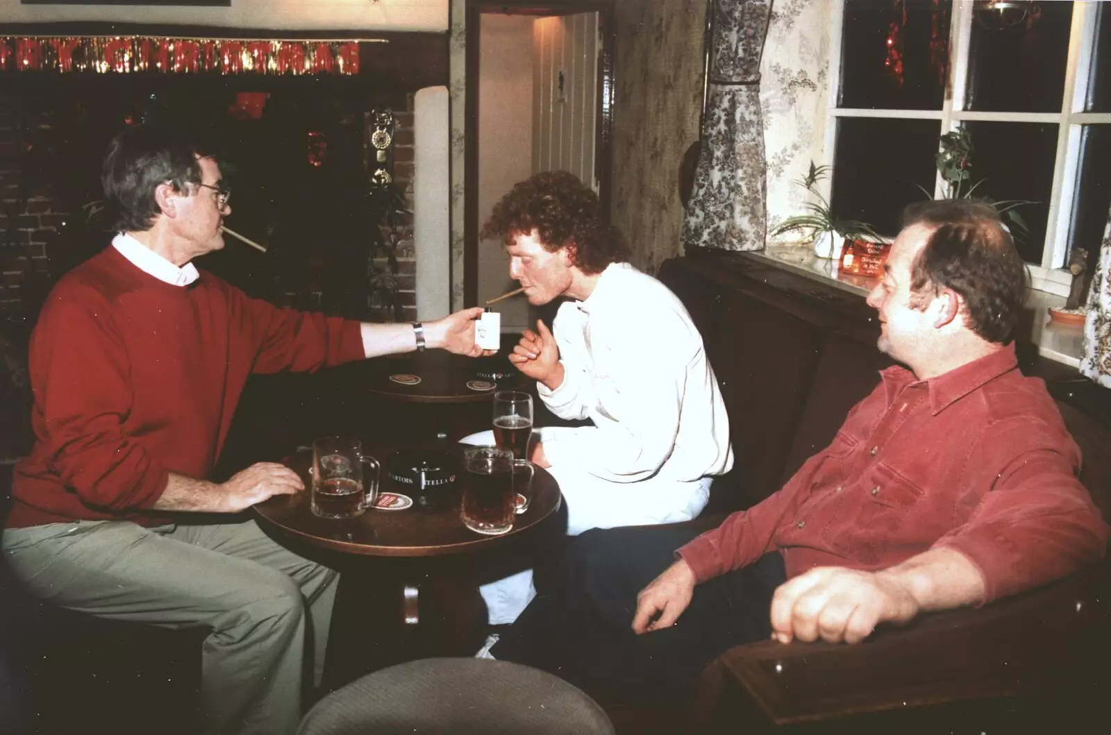 Peter and Wavy light up cigars as Ian looks on, from Brome Swan Christmas, Suffolk - December 1998