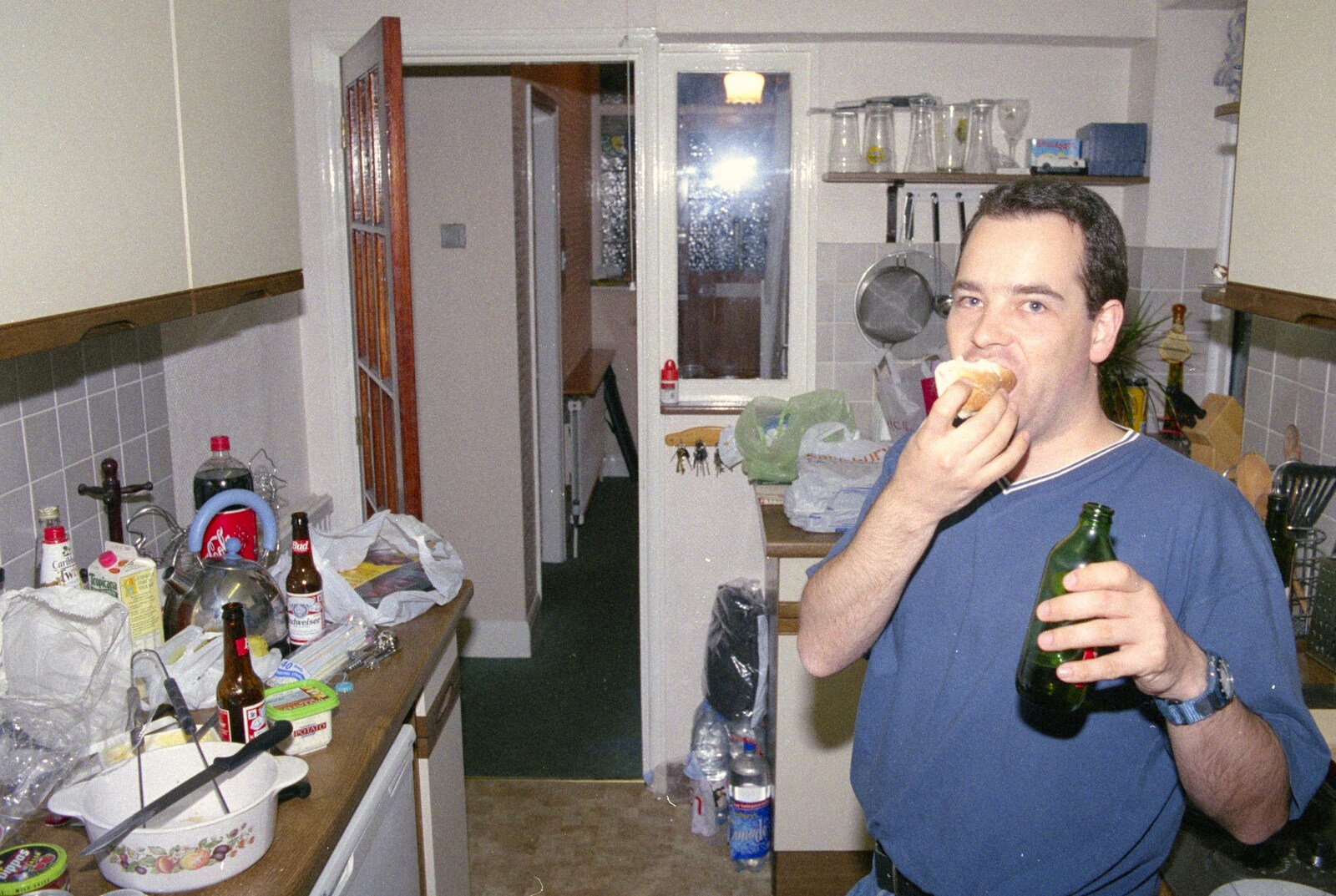 Russell shoves a bread roll in from A Mortlock Barbeque and a CISU Party, Suffolk - 11th July 1999