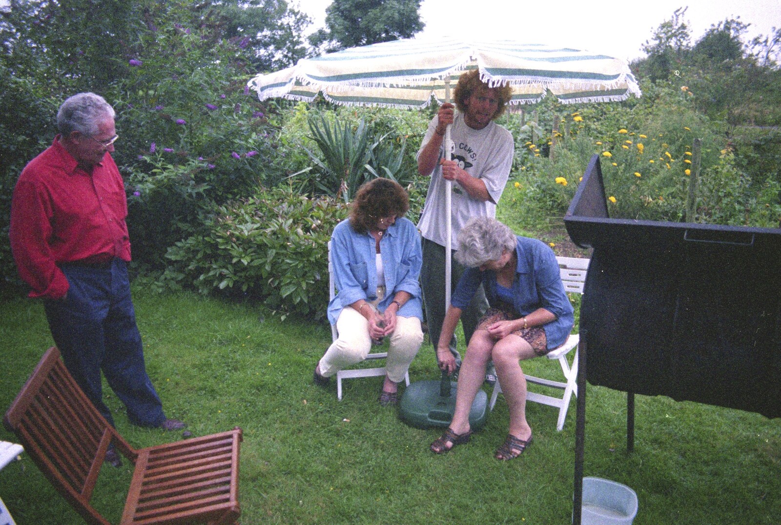 Wavy adjusts the parasol from A Mortlock Barbeque and a CISU Party, Suffolk - 11th July 1999