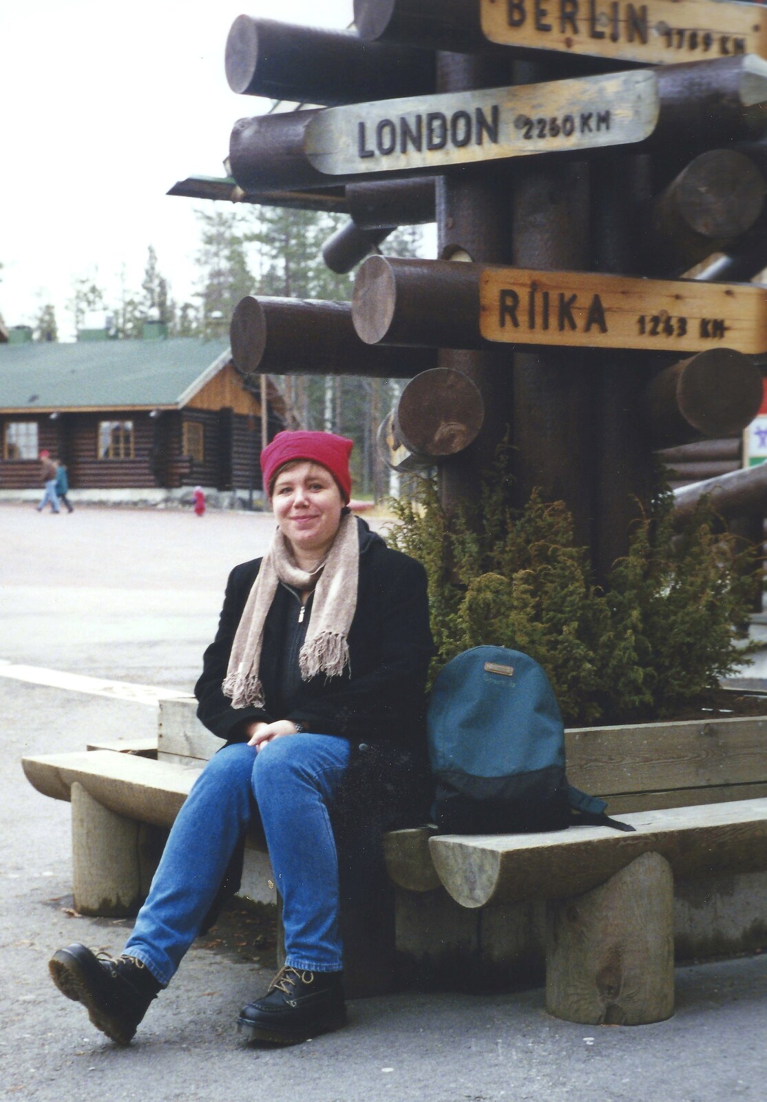 Sis sits by the 'where in the world' signs from A Trip to Rovaniemi and the Arctic Circle, Lapland, Finland - 28th November 1999