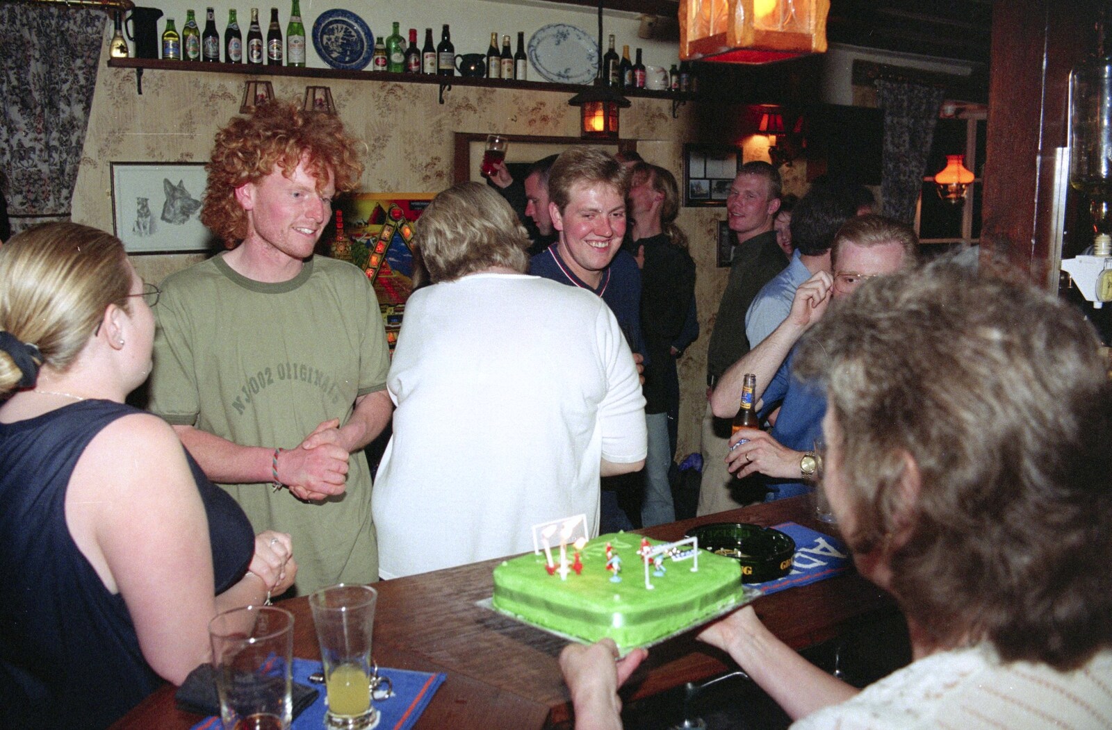 Sylvia hands over a football-themed cake from Wavy's Thirtieth Birthday, The Swan Inn, Brome, Suffolk - 24th May 2000
