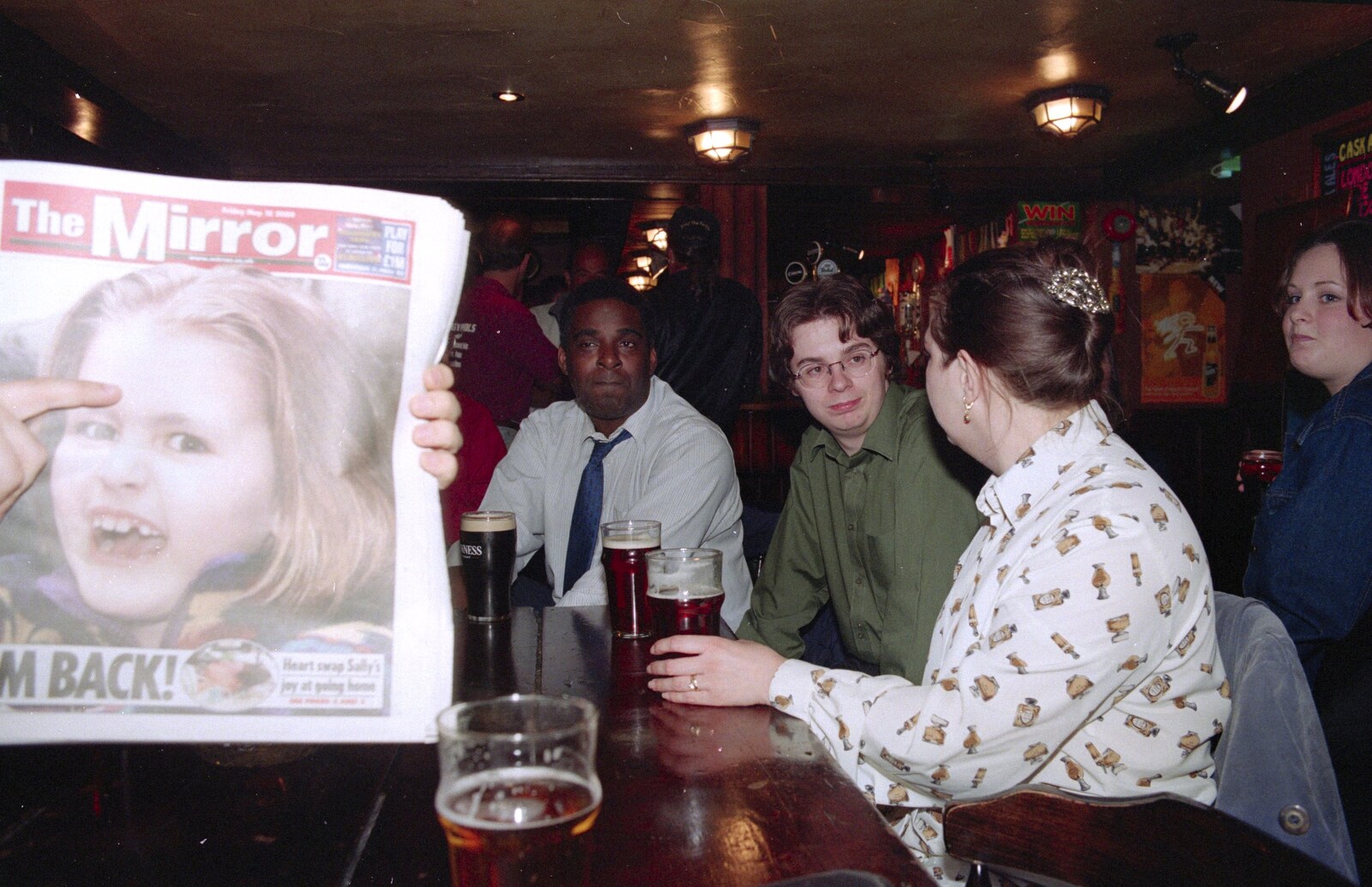 Russell holds up a newspaper with a scary kid  from CISU at the Dhaka Diner, Tacket Street, Ipswich - 25th May 2000