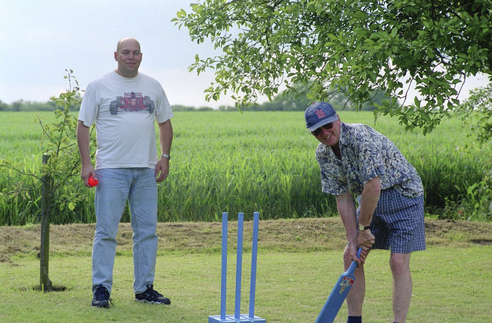 John Willy in bat, Dougie is wicket keeper from Colin and Jill's Barbeque, Suffolk - 28th May 2000