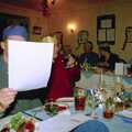 A hidden Paul looks at some paper, The BSCC Christmas Dinner, The Swan Inn, Brome, Suffolk - 8th December 2000