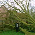2001 Claire stands next to the tree, for scale