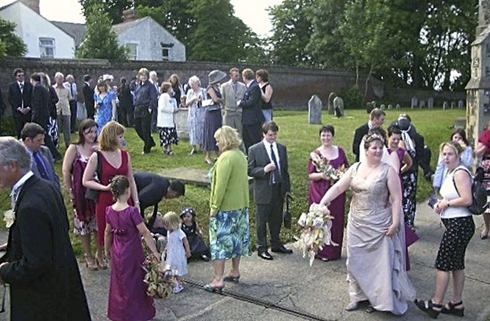 Guests mingle around outside the church from Phil and Lisa's Wedding, Woolverston Hall, Ipswich, Suffolk - 1st July 2001