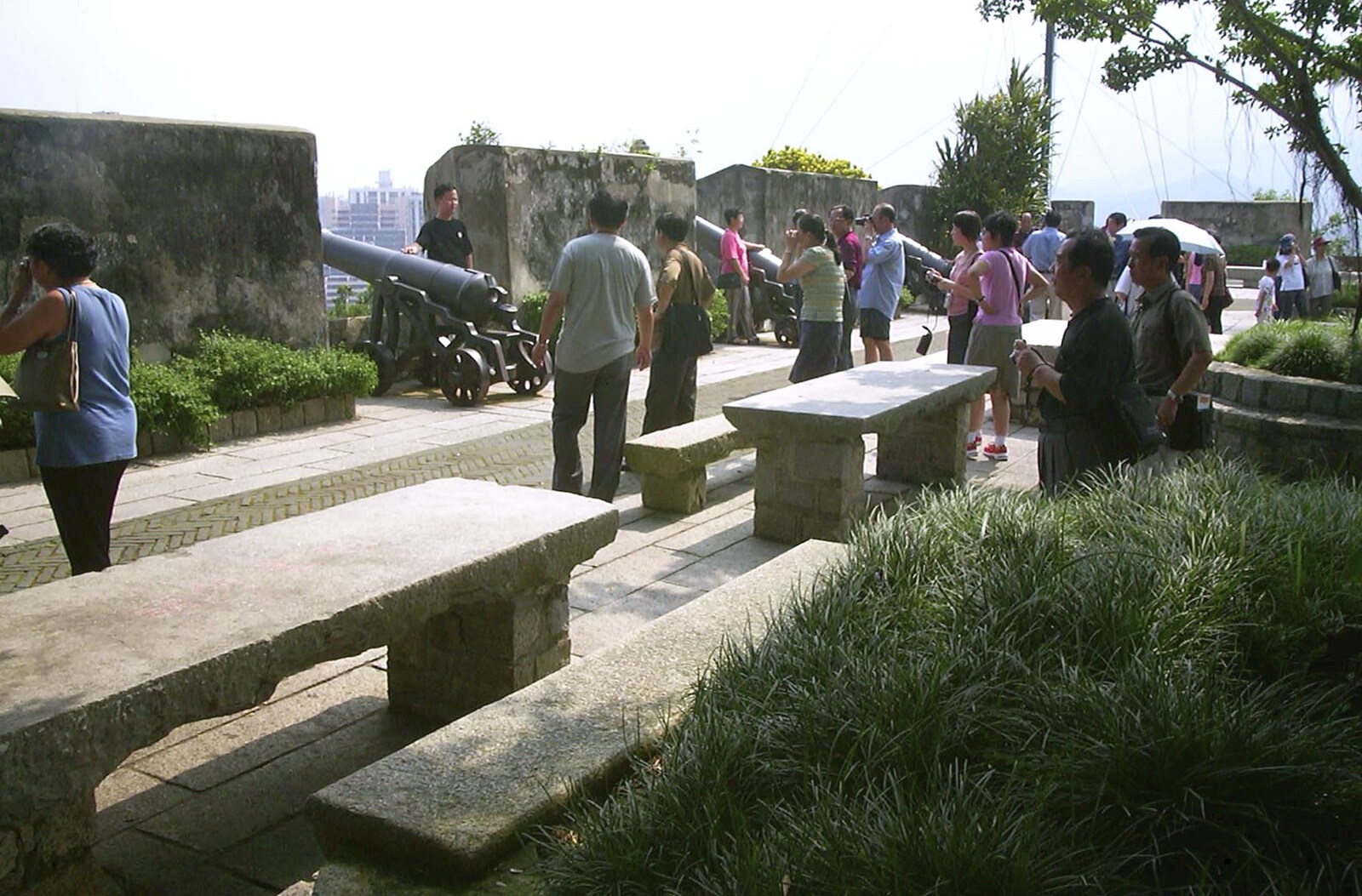 A Day Trip to Macau, China - 16th August 2001: Tourists look at cannon