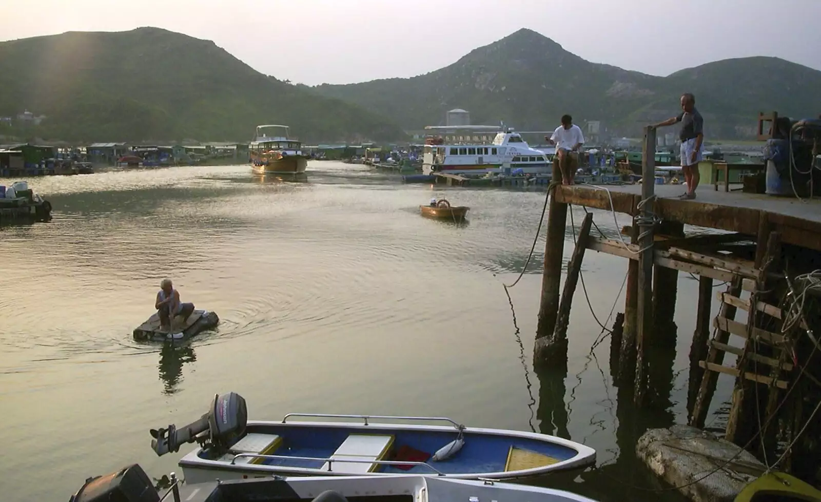 A woman ferries herself around on a cardboard box, from Lamma Island, Hong Kong, China - 20th August 2001