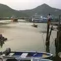 A woman ferries herself around on a cardboard box, Lamma Island, Hong Kong, China - 20th August 2001