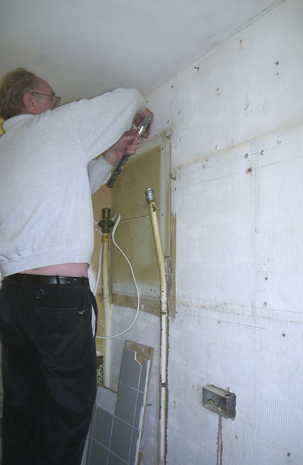 The Old Man pulls something out of the wall from Sis's Kitchen, Morden, London - 15th November 2001