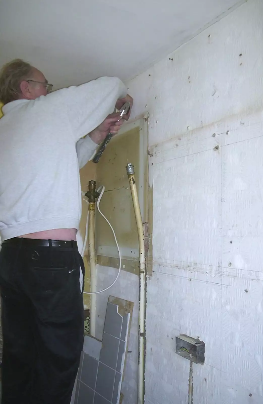 The Old Man pulls something out of the wall, from Sis's Kitchen, Morden, London - 15th November 2001