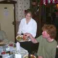 Wavy scavenges as Lorraine clears some plates away, The BSCC Christmas Dinner, Brome Swan, Suffolk - 7th December 2001