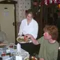 Wavy scavenges as Lorraine clears some plates away, The BSCC Christmas Dinner, Brome Swan, Suffolk - 7th December 2001