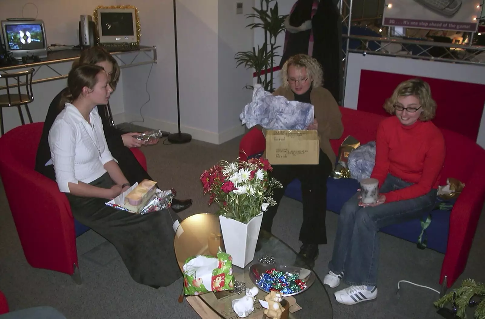 Kate, Genaya, Michelle and Wendy do presents, from 3G Lab Christmas Party, Q-Ton Centre, Cambridge - 20th December 2001