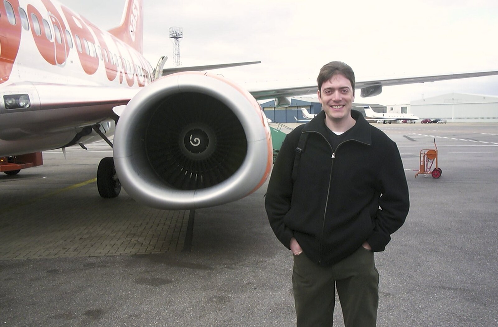 Stef pauses by our Easy Jet plane for a photo from 3G Lab Goes Skiing In Chamonix, France - 12th March 2002