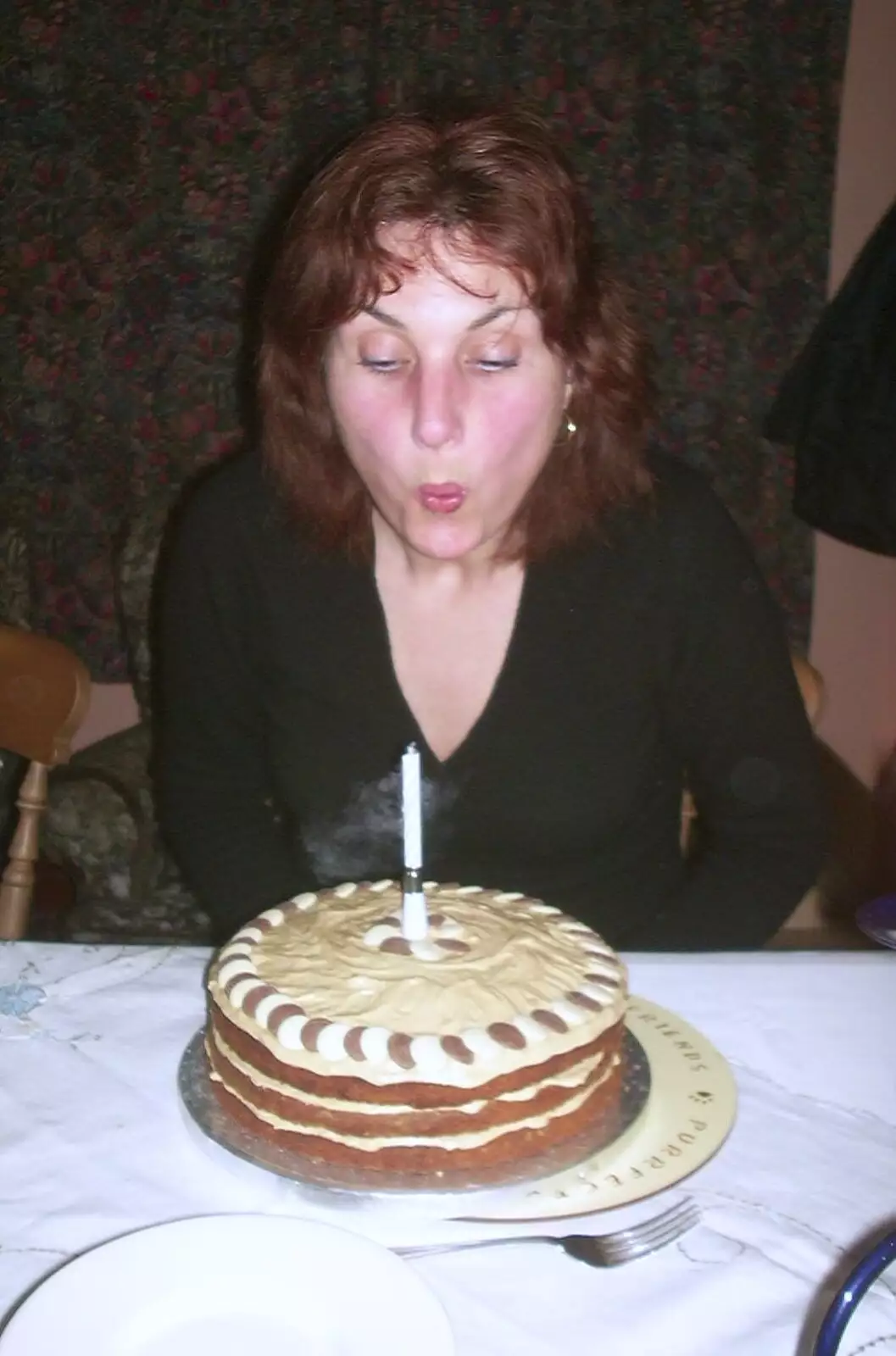 Anne blows her single candle out, from Anne's Birthday Curry and Cake, The Swan Inn, Brome - 24th March 2002