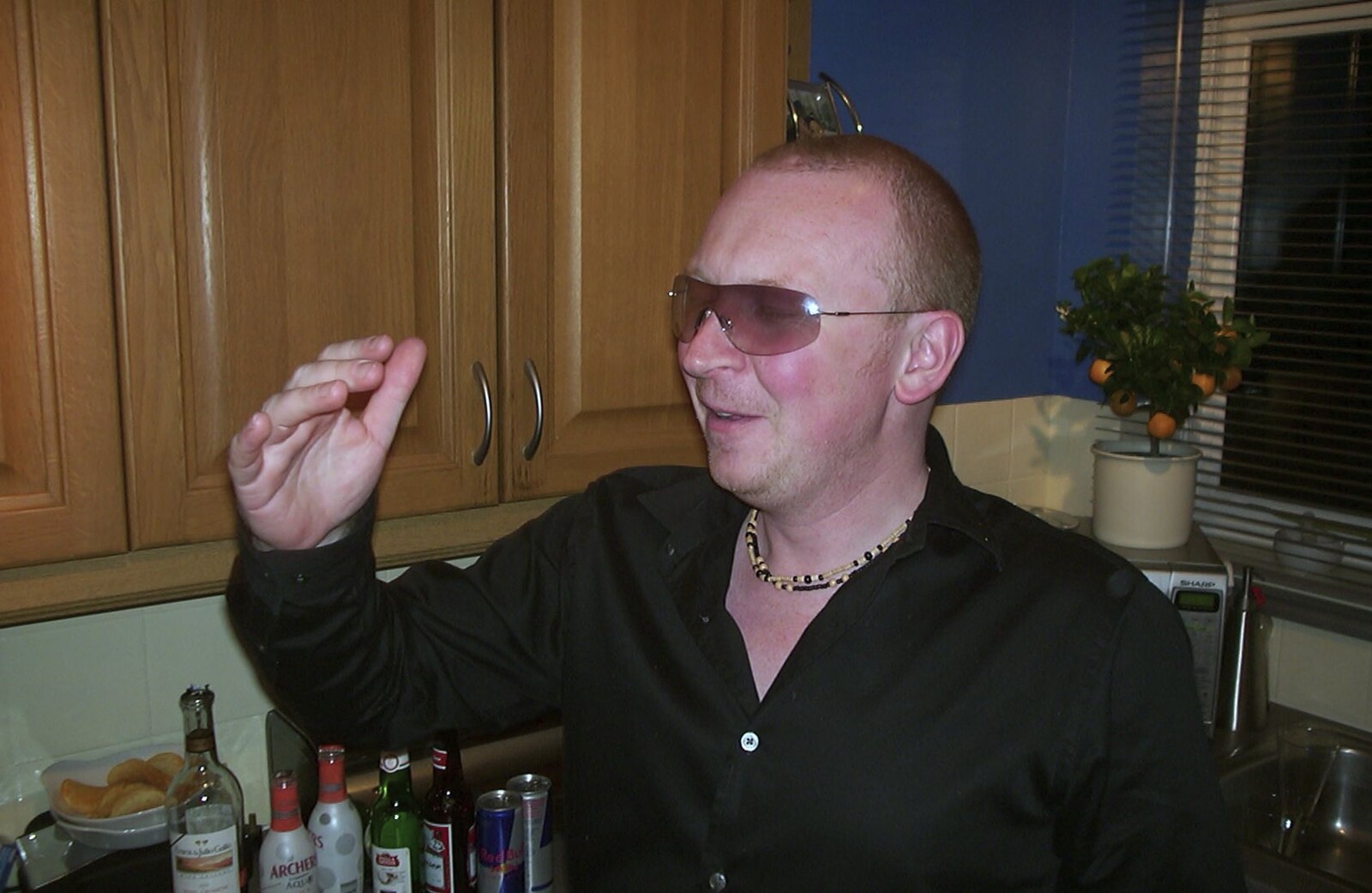 In Michelle's kitchen, Julian models his shades from 3G Lab's Carwash Nightclub by Limo, London - 27th April 2002