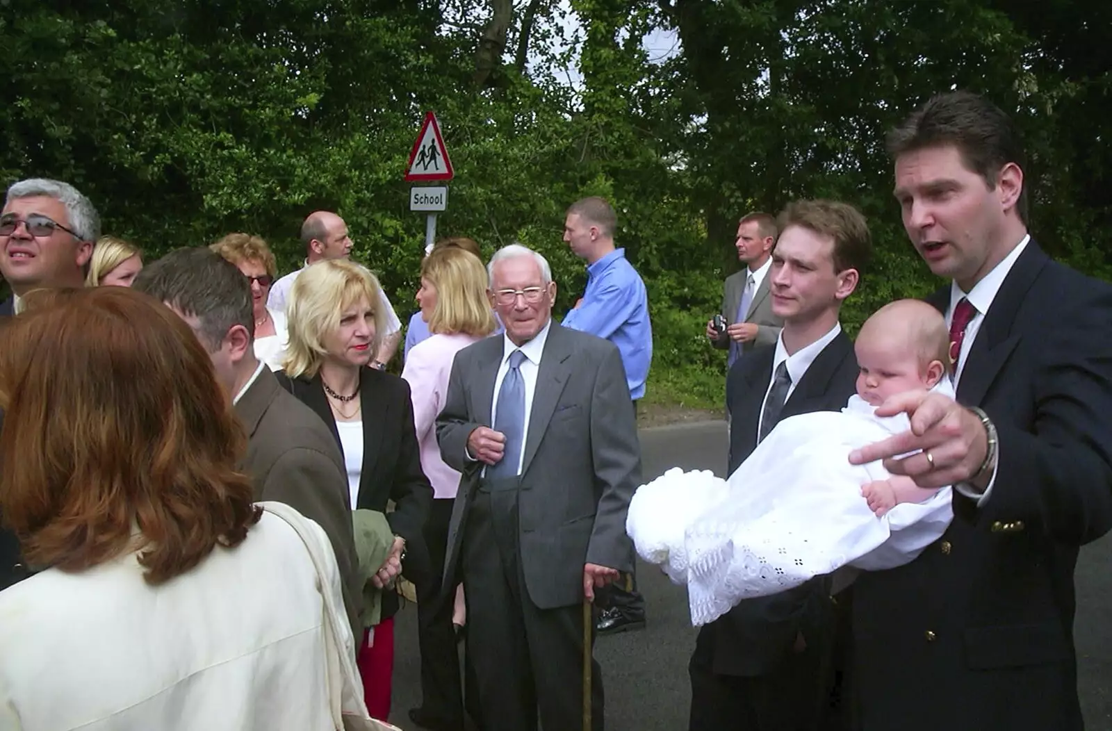 Sean points as people mingle around, from Sydney's Christening, Hordle, Hampshire - 4th May 2002