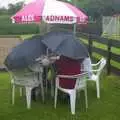 Hardy barbeque-ers huddle under umbrellas, A Rainy Barbeque at the Swan Inn, Brome, Suffolk - 15th June 2002