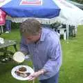 Nigel shows off his lunch, A Rainy Barbeque at the Swan Inn, Brome, Suffolk - 15th June 2002