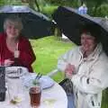 Spam and Jill with umbrellas, A Rainy Barbeque at the Swan Inn, Brome, Suffolk - 15th June 2002