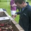 Apple grabs some meat, A Rainy Barbeque at the Swan Inn, Brome, Suffolk - 15th June 2002