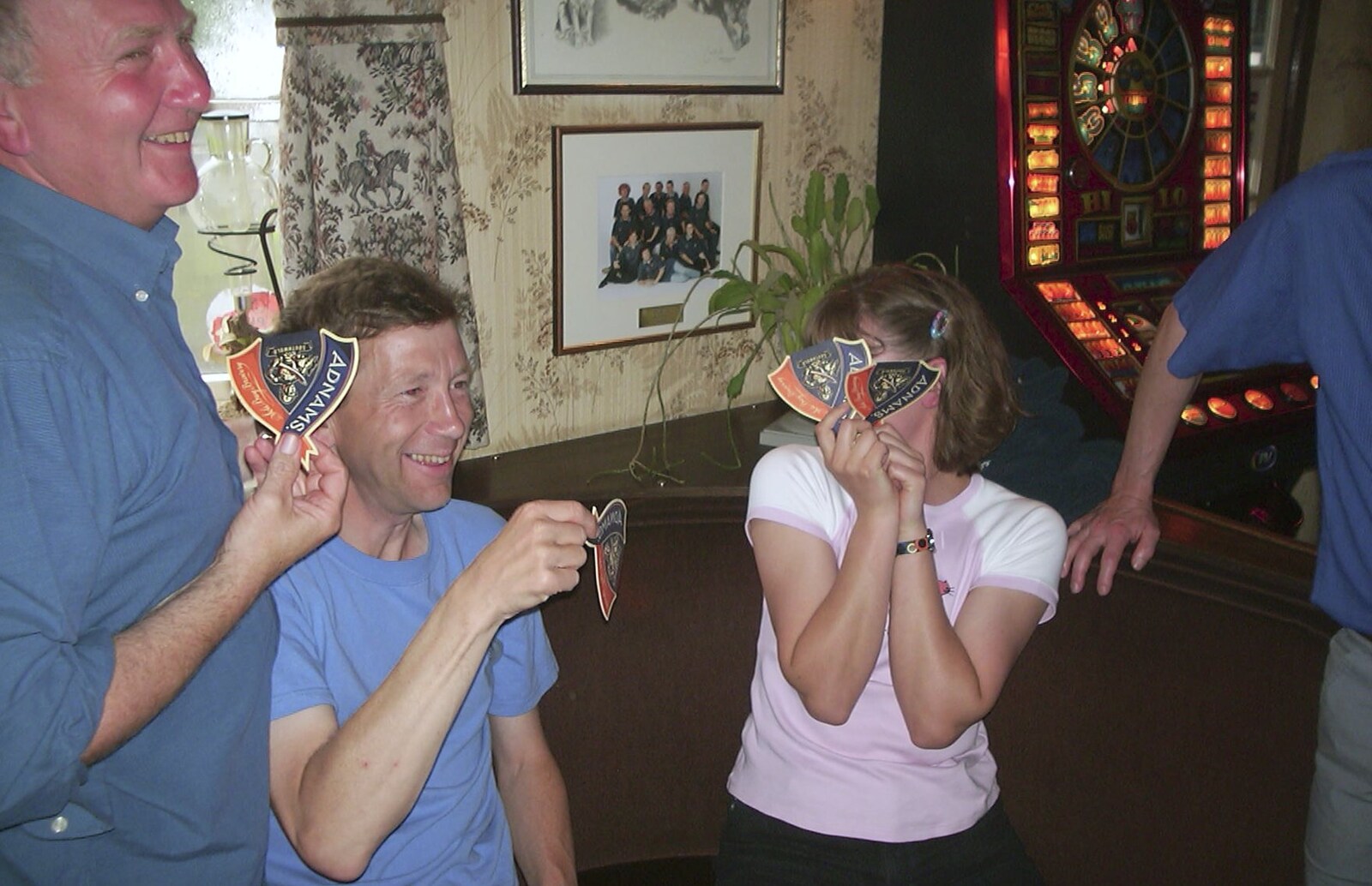 A Rainy Barbeque at the Swan Inn, Brome, Suffolk - 15th June 2002: Suey hides behind beer mats