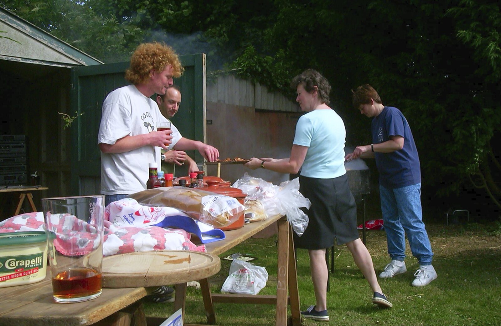 Sylvia hands some food around from DH's BSCC Barbeque, The Old Post Office, Brome, Suffolk - 7th July 2002