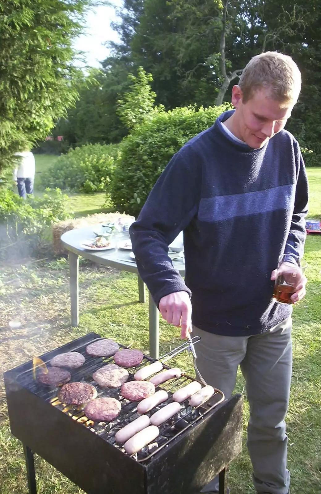 Bill pokes around some sausages, from DH's BSCC Barbeque, The Old Post Office, Brome, Suffolk - 7th July 2002