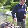 Bill pokes around some sausages, DH's BSCC Barbeque, The Old Post Office, Brome, Suffolk - 7th July 2002