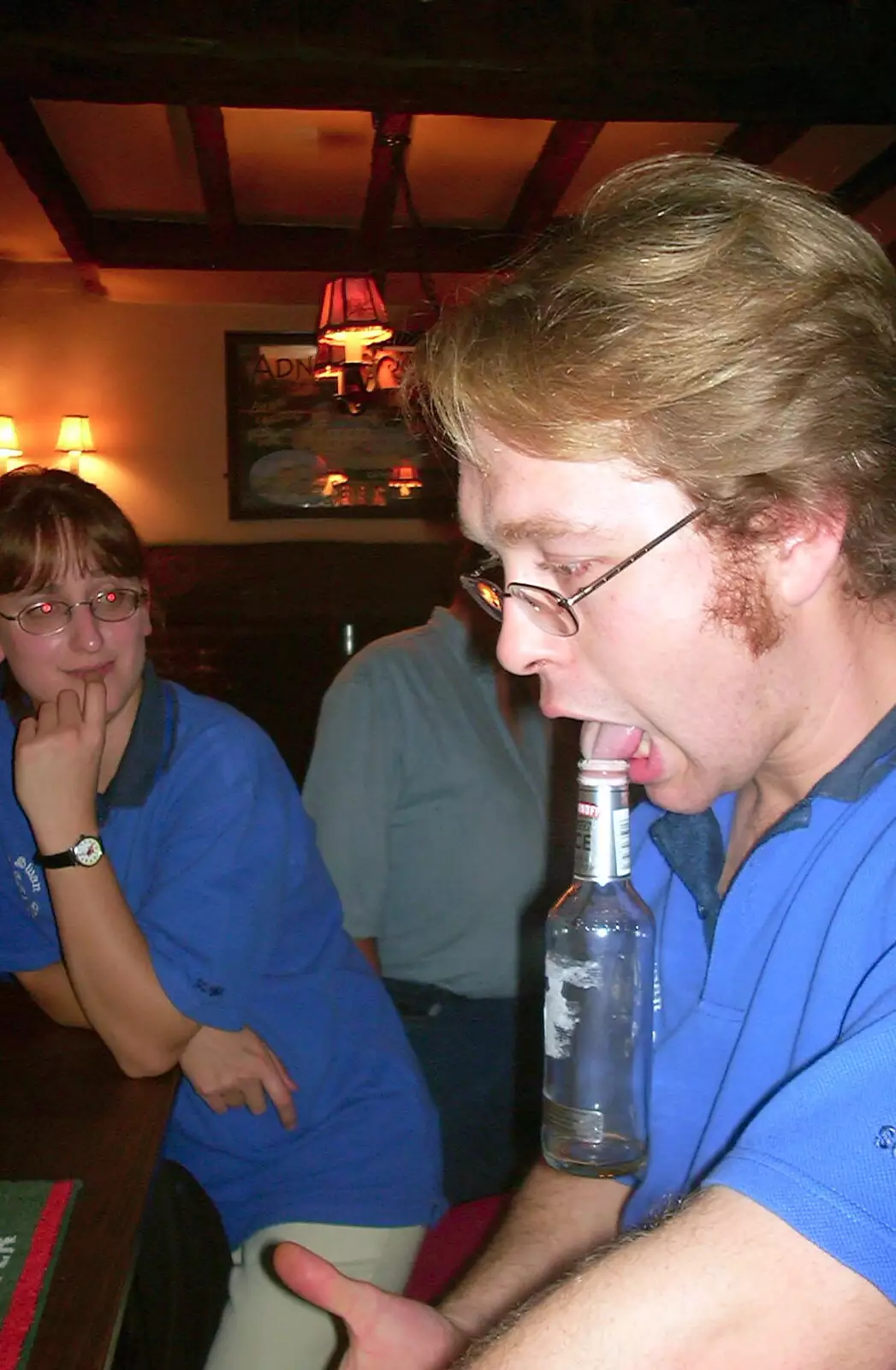 Marc holds a bottle up with a tongue vacuum, from A BSCC Presentation, Brome Swan, Suffolk - 9th November 2002