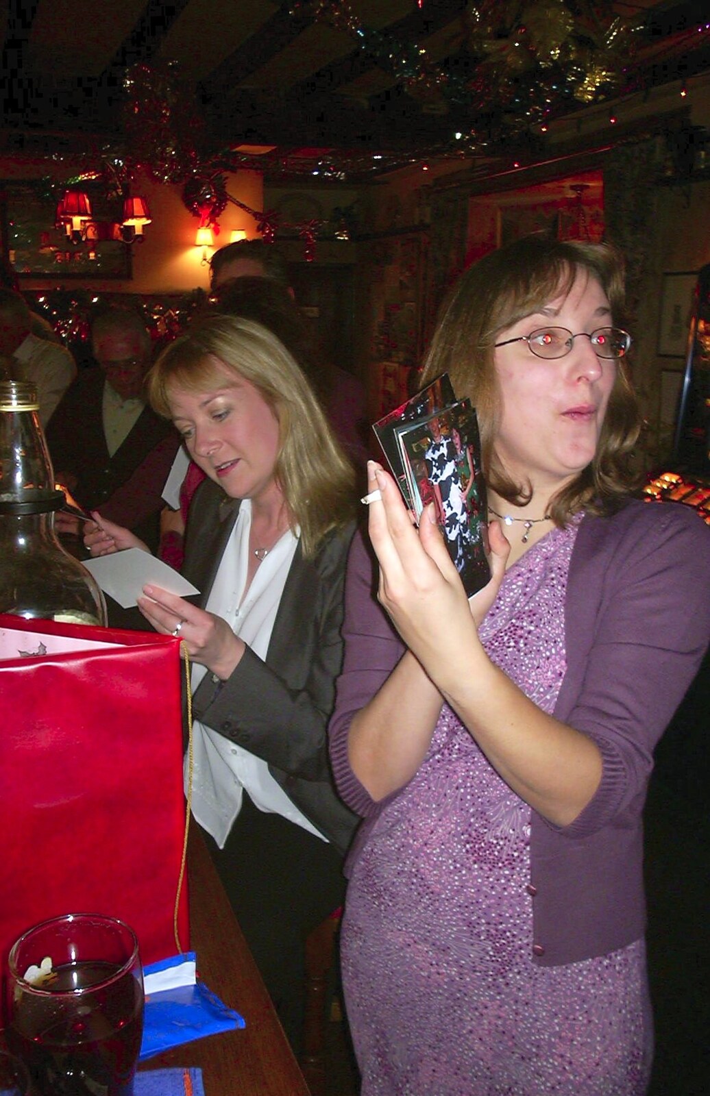 Caroline and Suey look at photos from The BSCC Christmas Dinner, Brome Swan, Suffolk - 10th December 2002