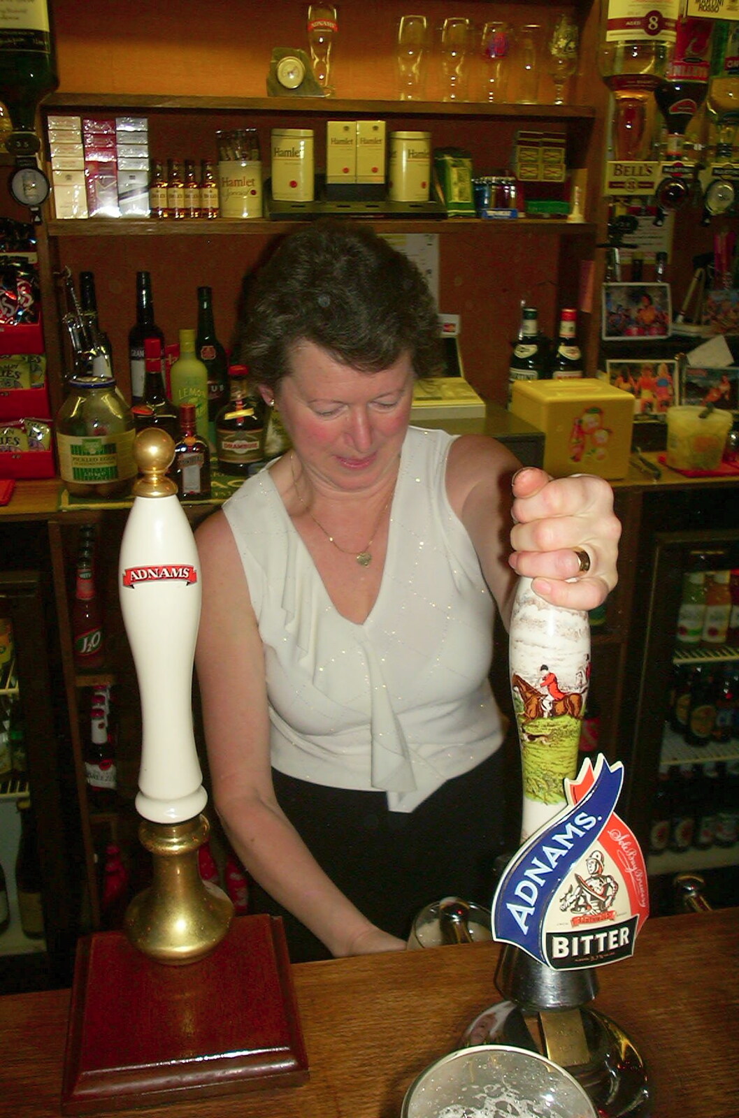 New Year's Eve at the Swan Inn, Brome, Suffolk - 31st December 2002: Syliva pulls a pint