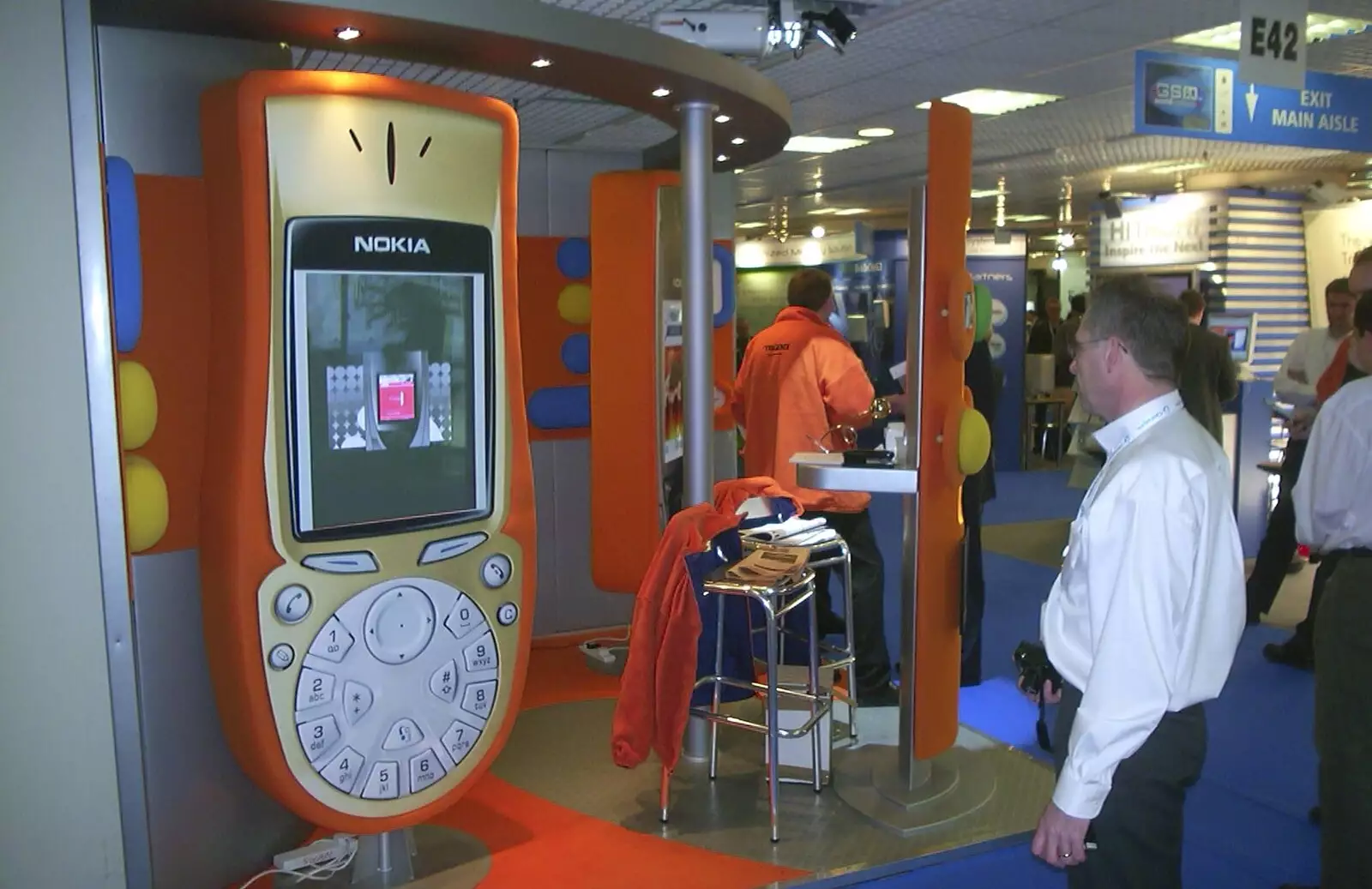 Some dude looks at the giant phone, from 3G Lab at the 3GSM Conference, Cannes, France - 17th February 2003