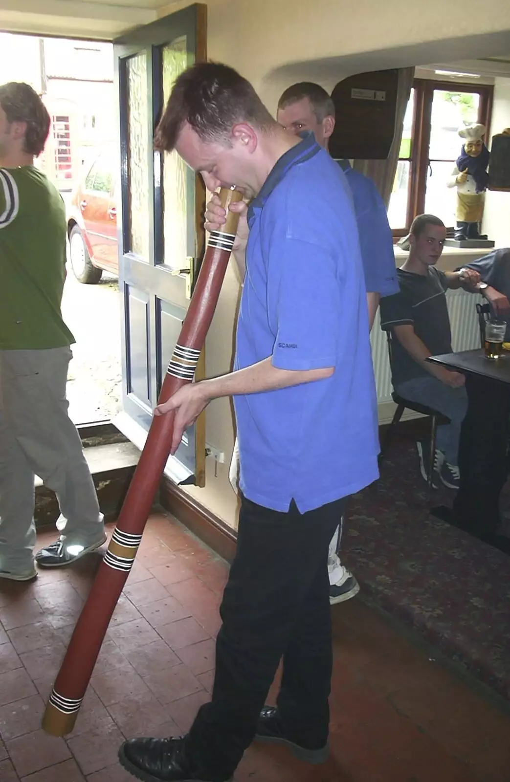 Nosher gives it a blow on the didgeridoo, from The BSCC Bike Ride Weekend, Kelling, Norfolk - 9th May 2003