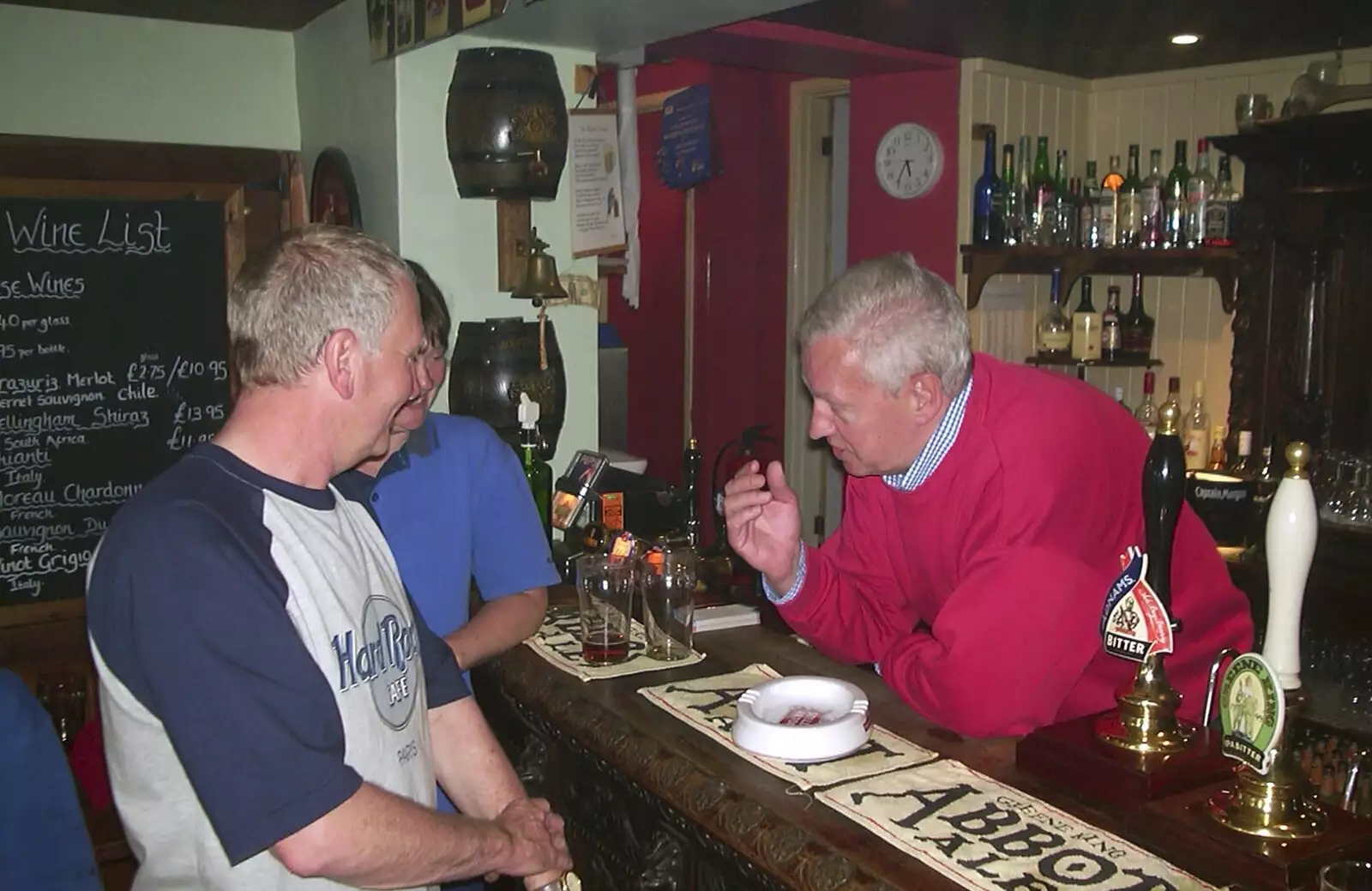 John Willy chats with the barman, from The BSCC Bike Ride Weekend, Kelling, Norfolk - 9th May 2003